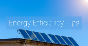 Solar panels on a rooftop under a clear blue sky with overlay text stating ‘Energy Efficiency Tips