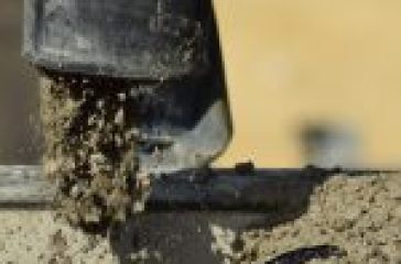 Concrete being poured from a hose.