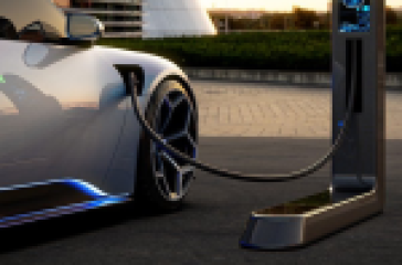 An electric car charging at a charging station.