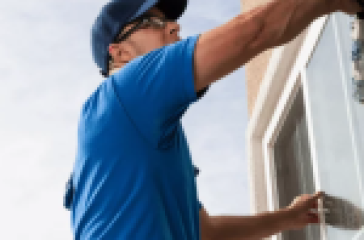Professional window cleaning service maintaining window tint quality.