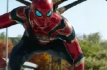 Spider-Man in his Iron Spider suit with mechanical arms extended, crouching in an urban setting.
