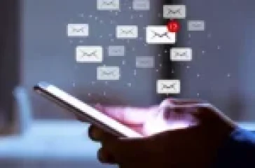 A laptop screen displaying an email marketing dashboard with outreach metrics.