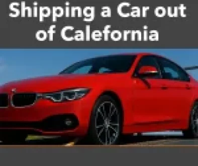 Red sports car loaded on an open transport trailer under a blue sky, representing California auto shipping services
