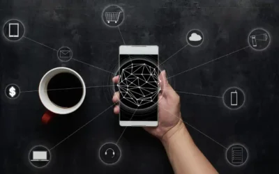 Hand holding smartphone with digital network icons representing cloud, shopping, communication, and finance on black background.