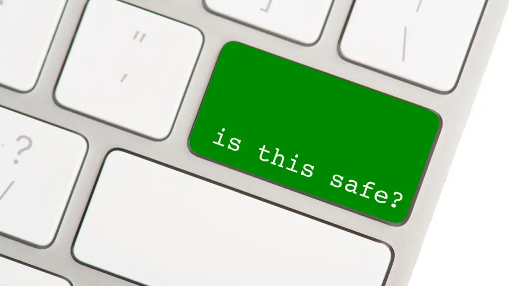 Bright green keyboard key labeled "is this safe?" highlights the importance of online security and cautious digital behavior.