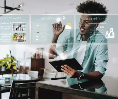 A Young Man, With An Afro And Casual Shirt, Interacts With A Holographic, Transparent Screen Displaying Information Like Weather, News Headlines, And A Diet Plan, While Holding A Tablet In His Hands, Illustrating The Concept Of Ambient Intelligence And Futuristic Ai Interaction In A Home Setting.