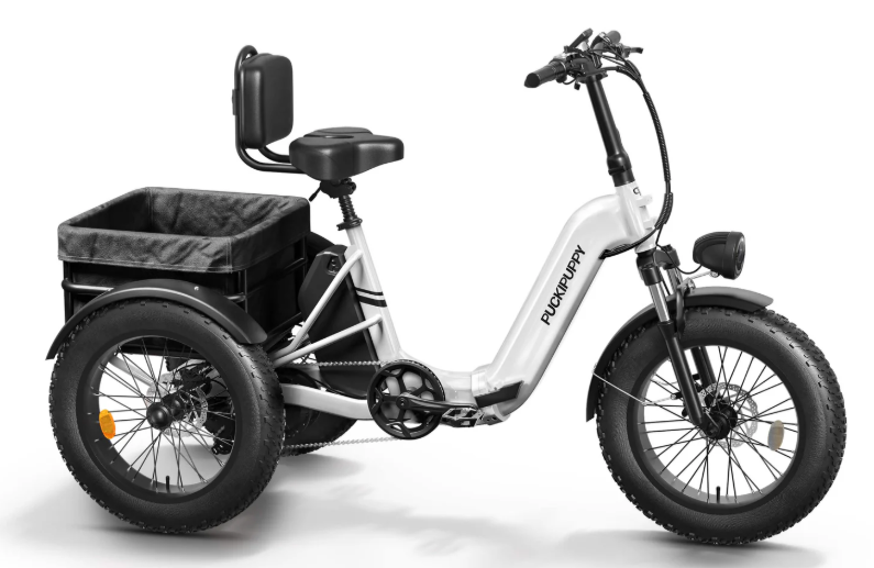 White Pupikpuppy fat-tire electric trike with large rear cargo basket, step-through frame, and comfortable backrest seat against clean white background.