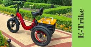Red Puckipuppy Husky electric trike with fat tires and rear cargo basket, parked on a garden path surrounded by lush green hedges and vibrant flowers, showcasing its stylish design for outdoor adventures.