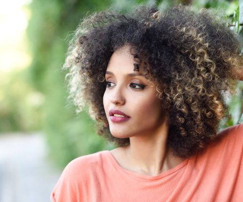 Woman With Defined Curly Hair Styled In Professional Updo For Work