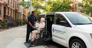 Reliable Ambulette Services in Brooklyn: What Patients and Families Should Know 5 A uniformed driver providing ambulette services in Brooklyn assists an elderly woman in a wheelchair as she boards a specialized medical transport van using a hydraulic lift on a tree-lined street.