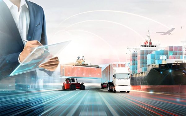 Business Professional Using A Digital Tablet With Cargo Ship, Trucks, Containers, And Airplane In The Background, Representing Route Optimization And Smart Global Logistics Management.