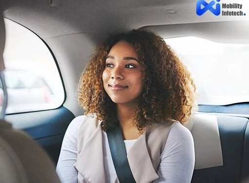 A Happy Female Passenger Riding Safely In The Back Seat Of A Ride-Hailing Cab With A Seatbelt On